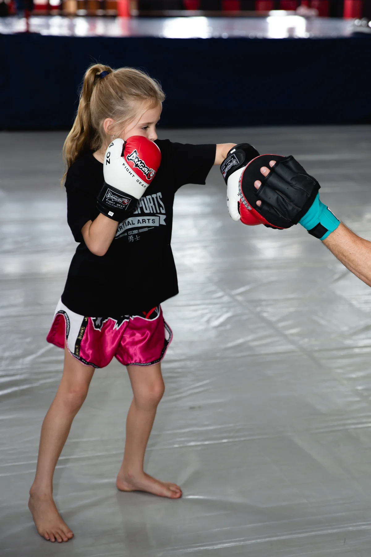 A young Warrior Sports student practising with pads