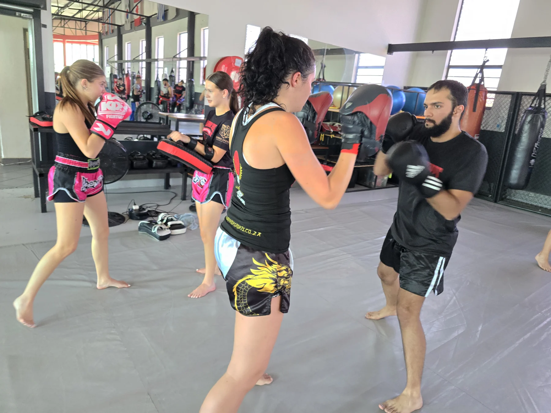 Warrior Sports members practising together with pads